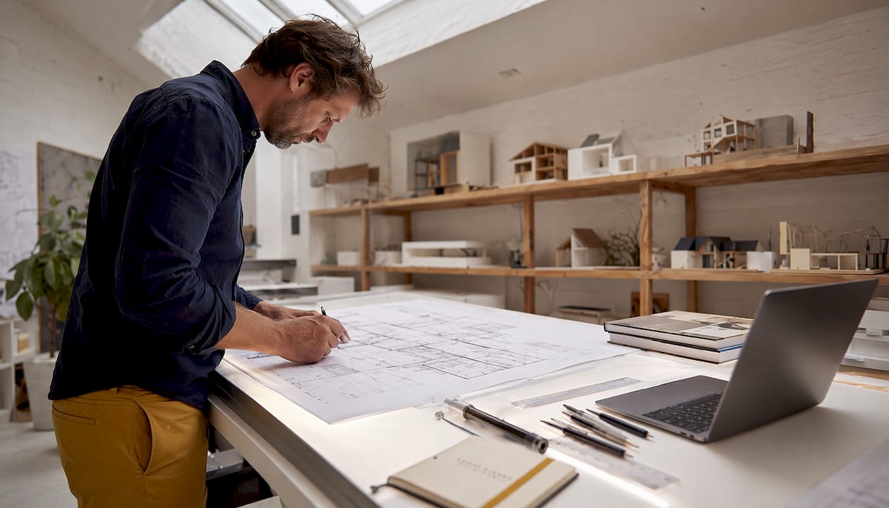 Architect sketching detailed floor plans