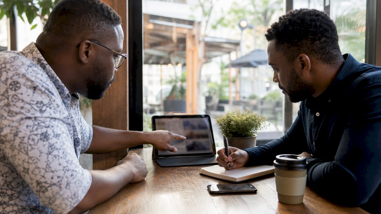 Two professionals collaborating over digital logistics tools