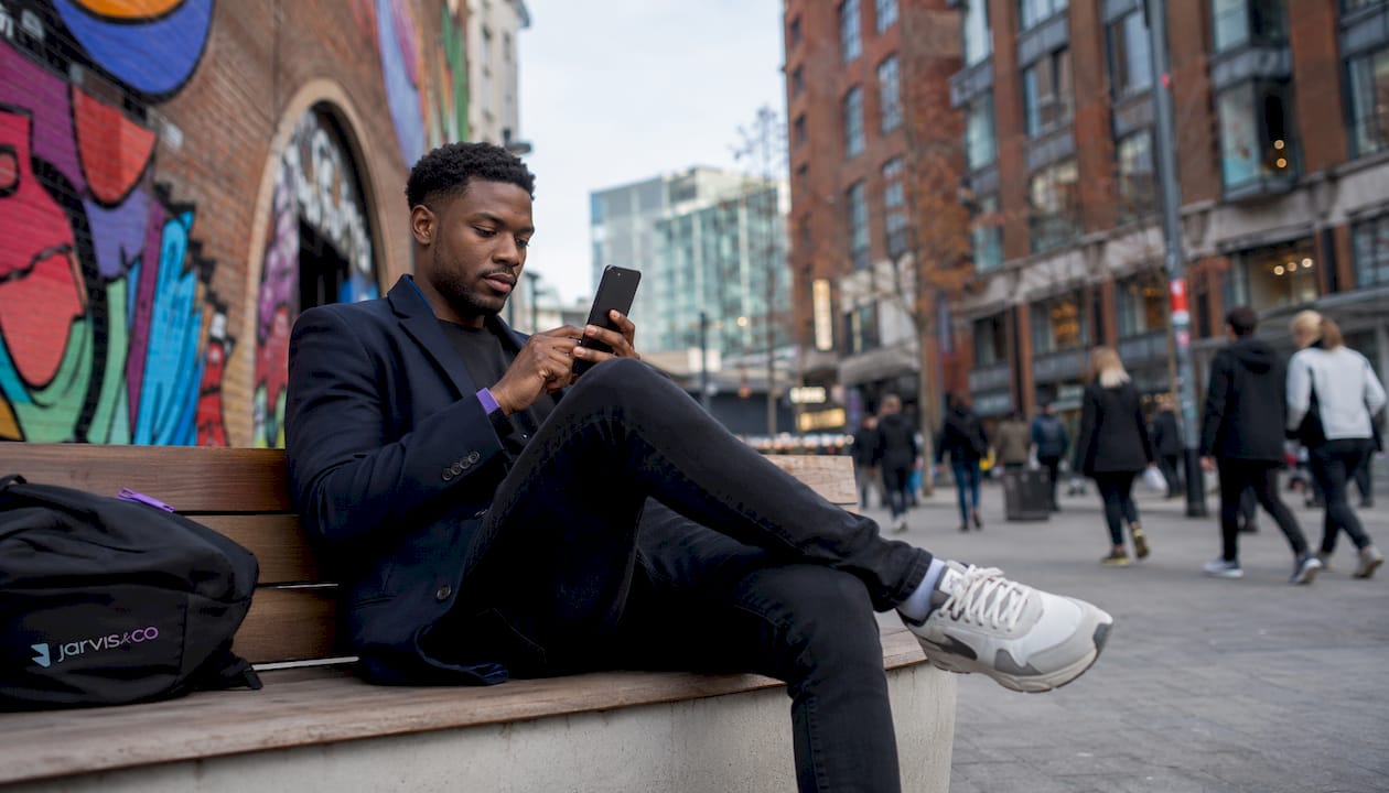 Person using mobile ecommerce site outdoors