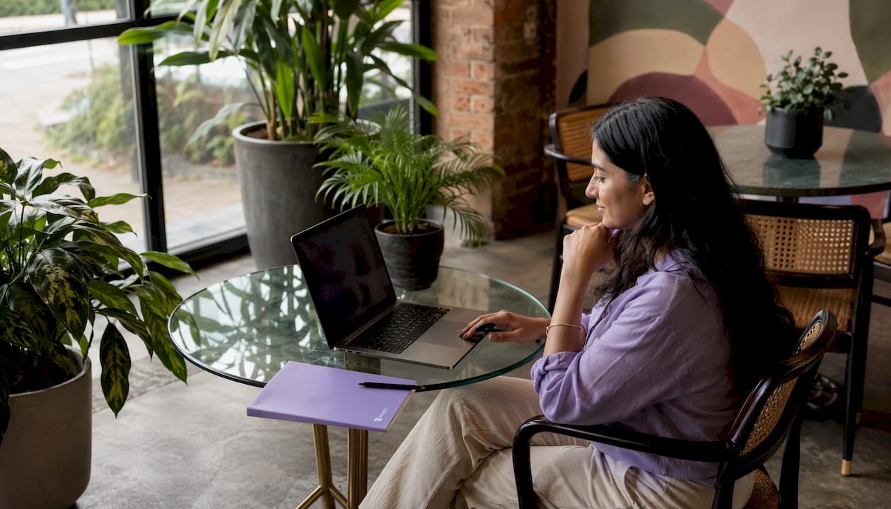 Woman reviewing video testimonials at home office