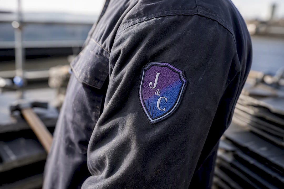 Badge-style tradesman logo patch on uniform