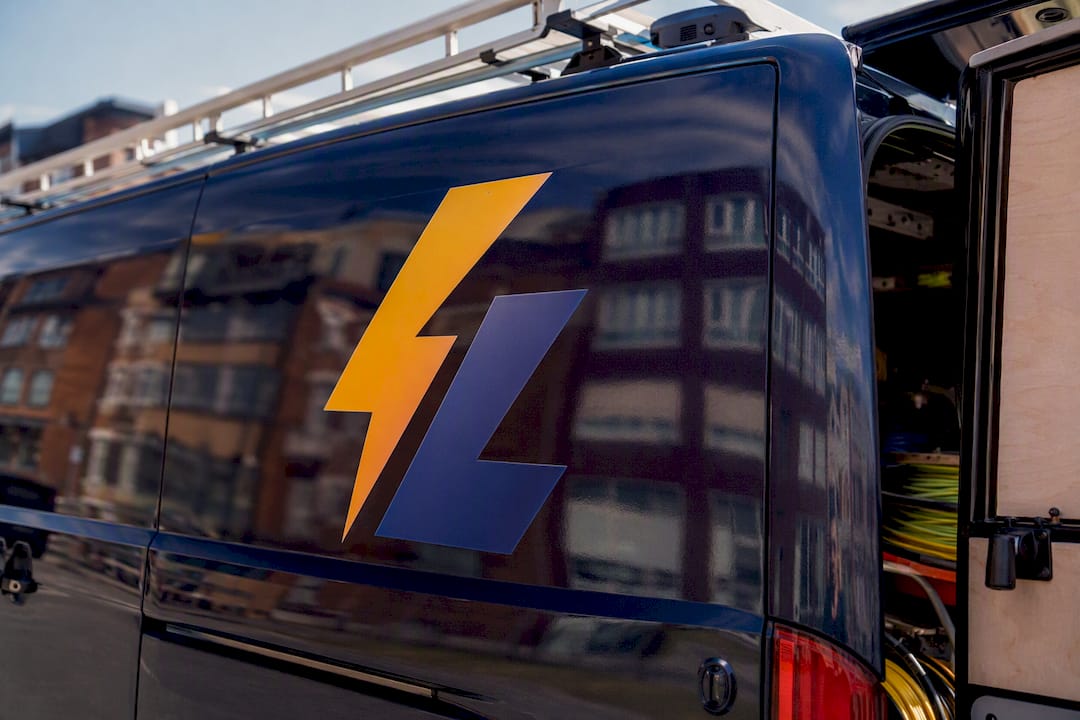 Electrician van with two-tone amber and navy logo