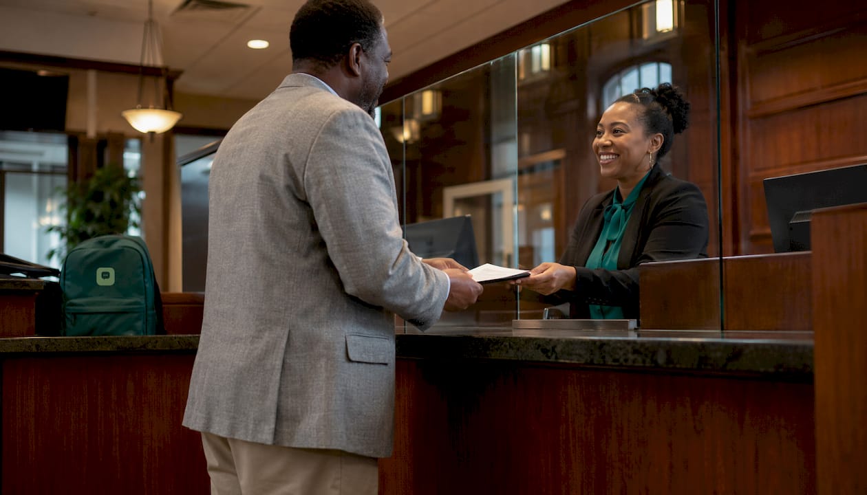 Customer submitting documents at bank branch