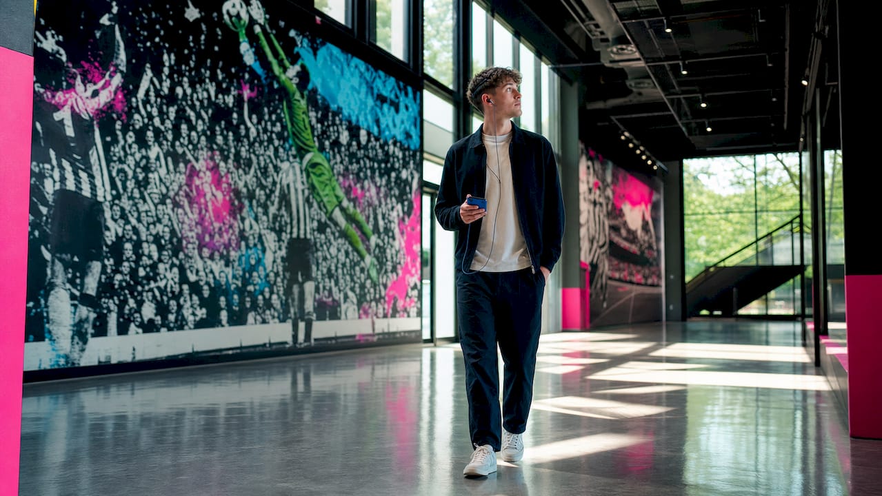 Visitor walking through stadium tour corridor