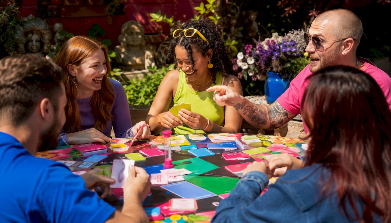 Hands playing large group party board game