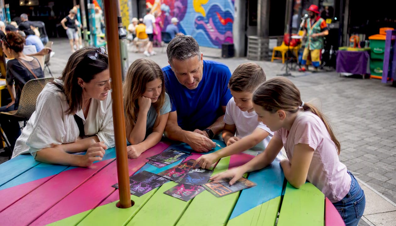 Family discussing escape room options at cafe