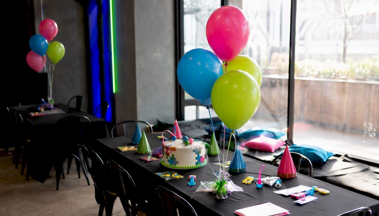 Decorated party room with balloons and treats