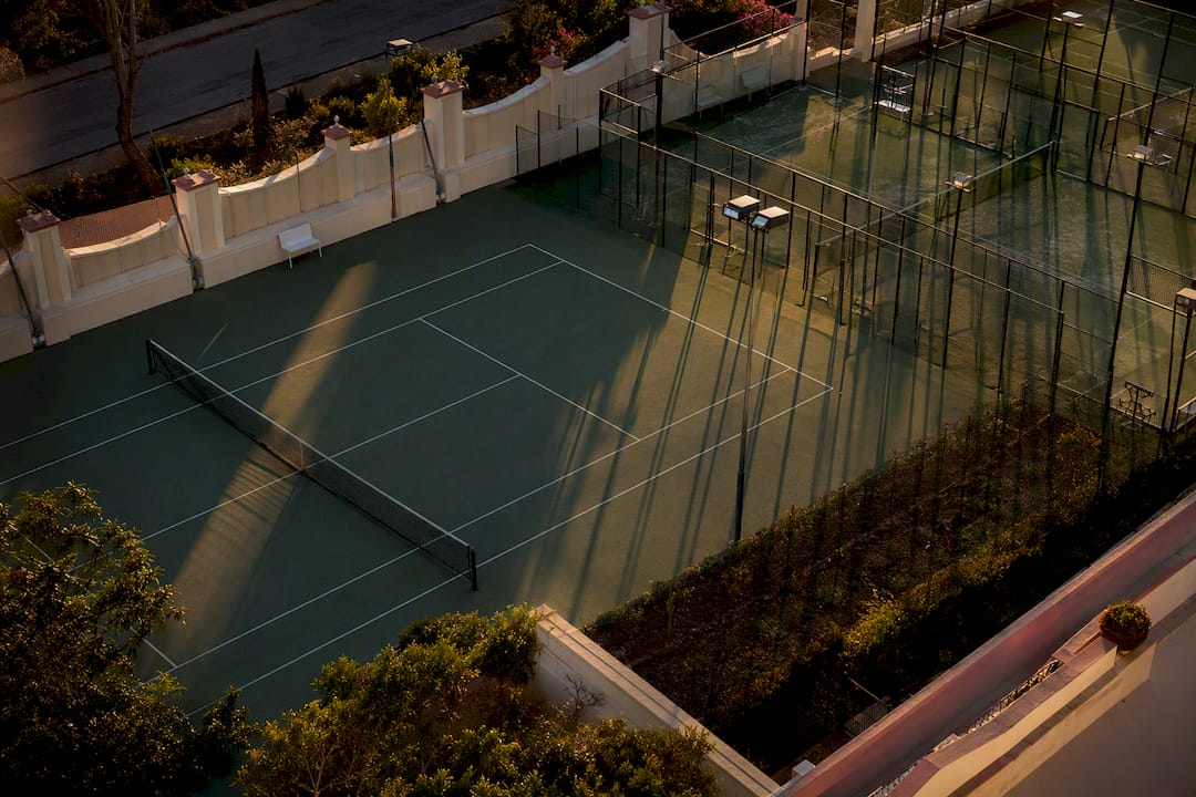 Empty racquet sports courts at sunset