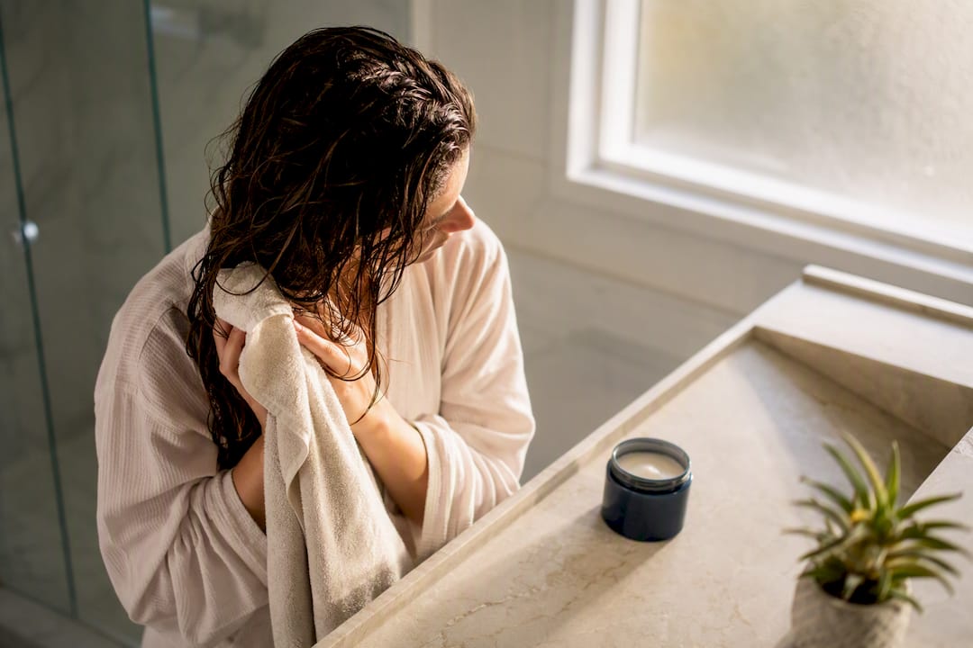 Woman gently towel drying wet hair