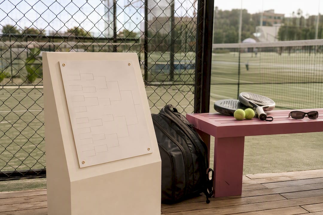 Padel tournament bracket on bench with sports gear