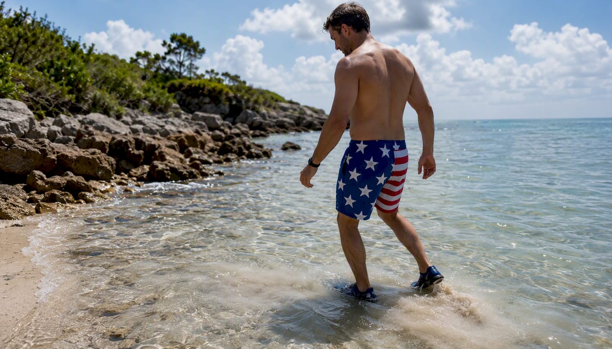 Person demonstrating stingray shuffle in shallow water