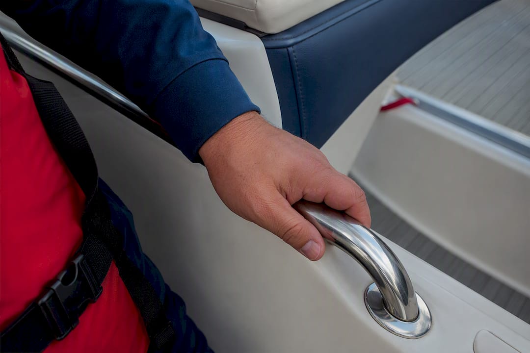 Passenger using a charter boat safety handhold