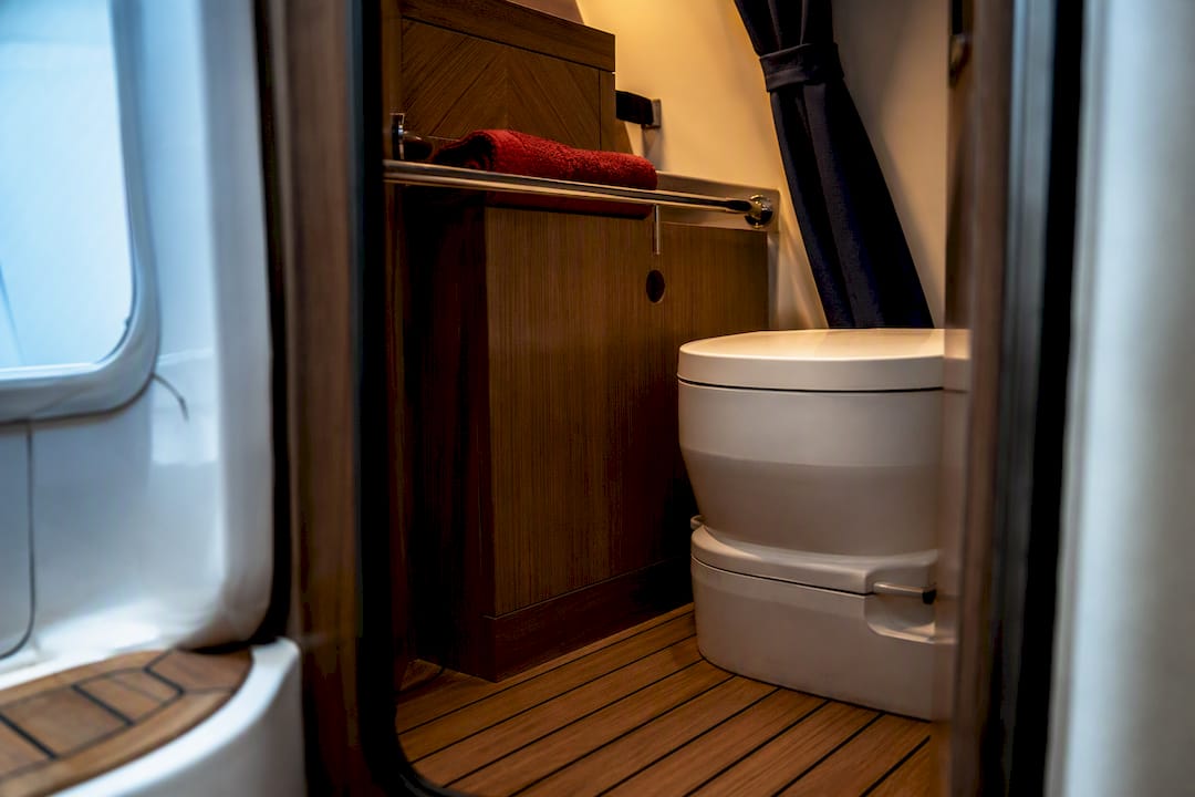 Compact portable toilet in small boat compartment