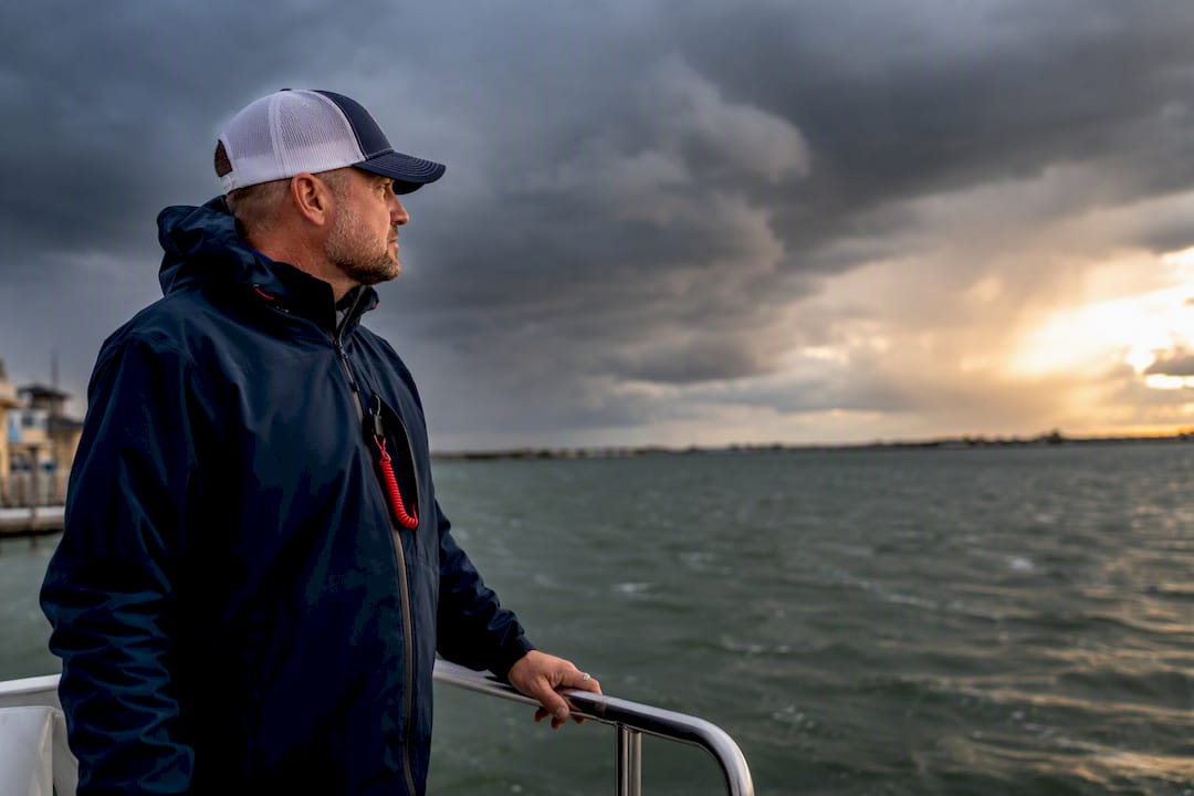 Captain assessing rough weather from harbor