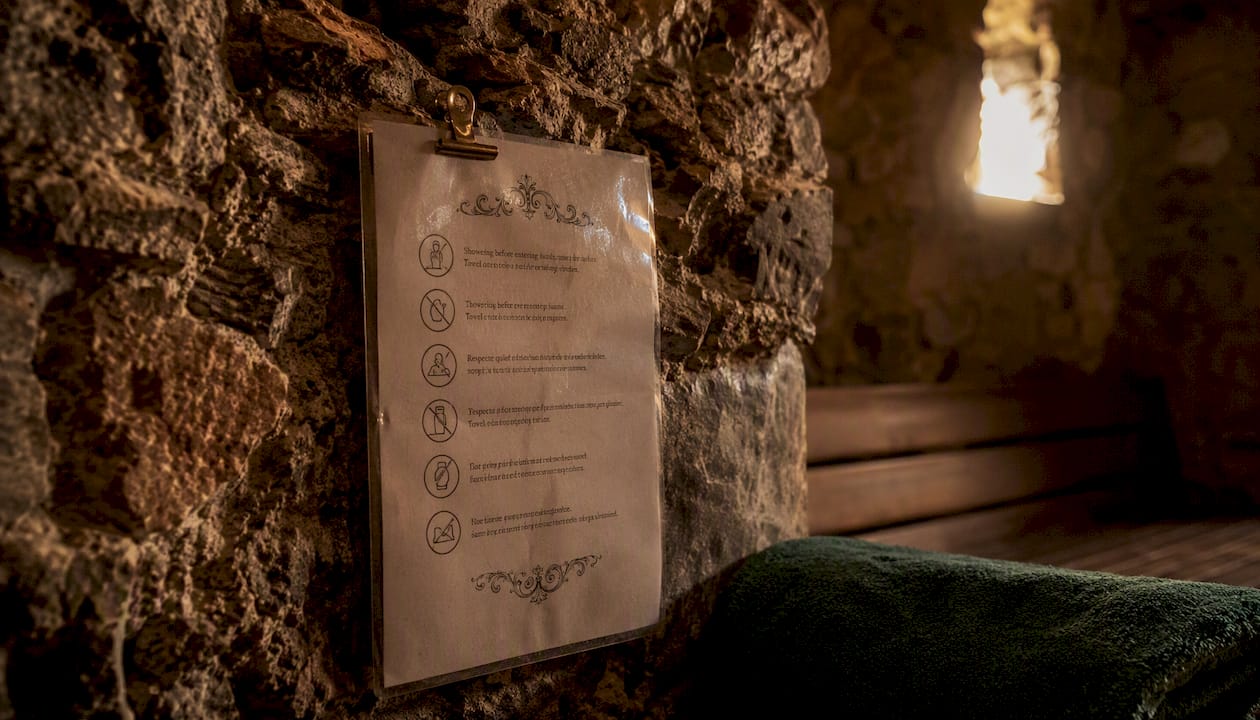 Laminated sauna rules sign inside wooden sauna