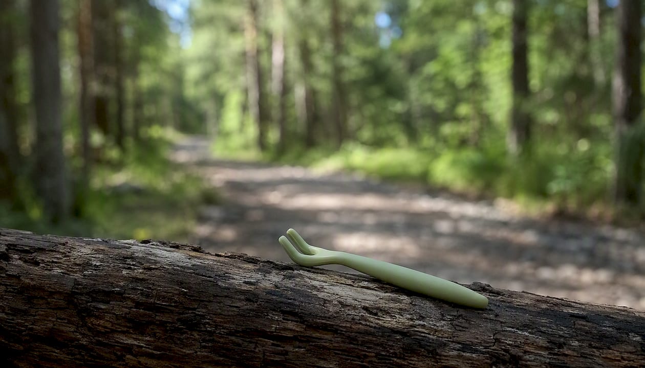 Tick remover tool clipped to daypack strap
