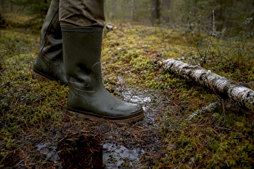 Rubber boots on damp forest ground
