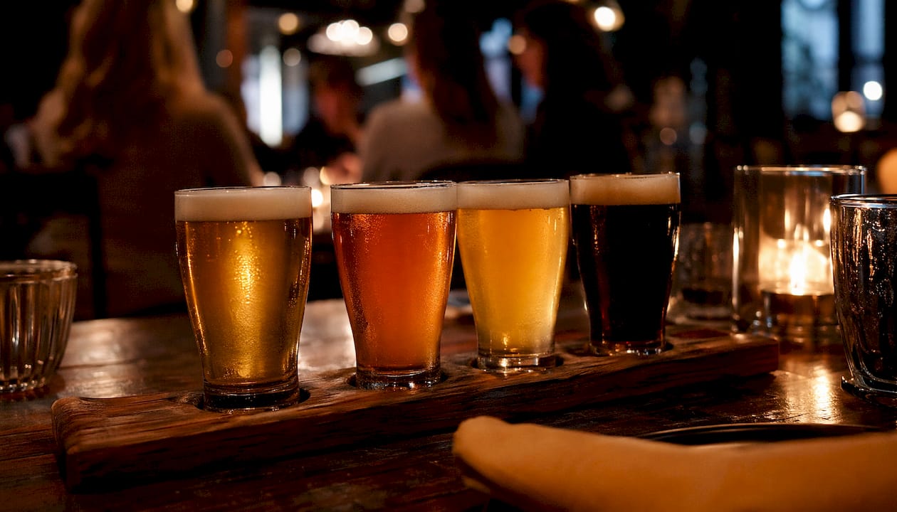 Close-up of craft beer flight samples on wooden paddle