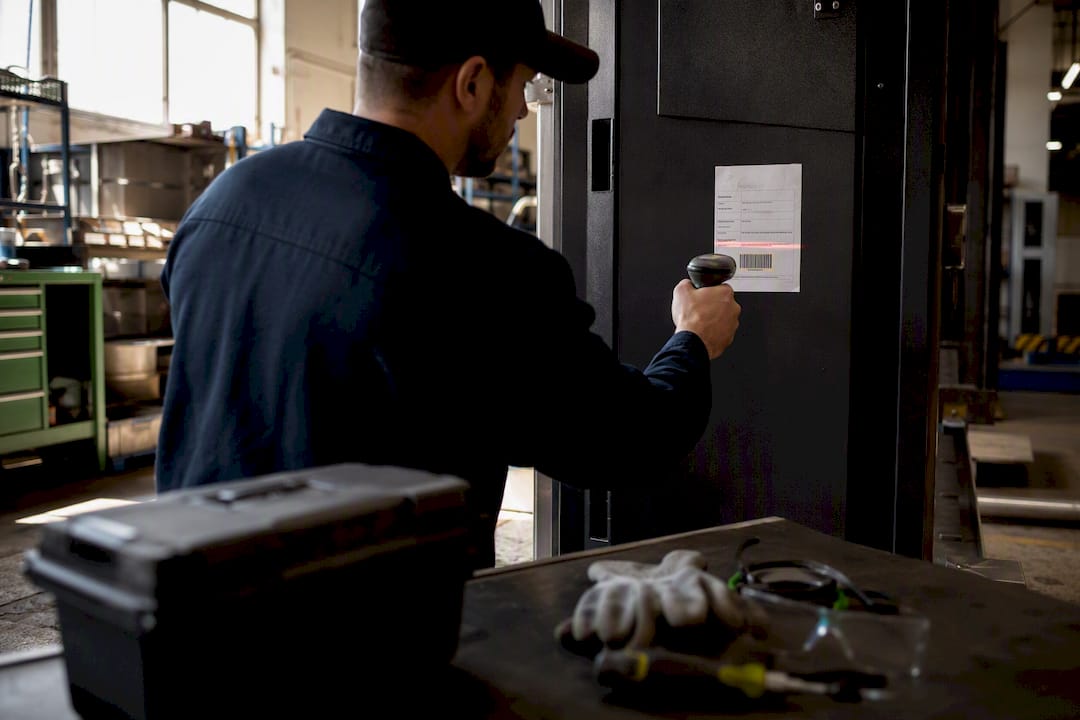 Technician scanning barcode on work order label