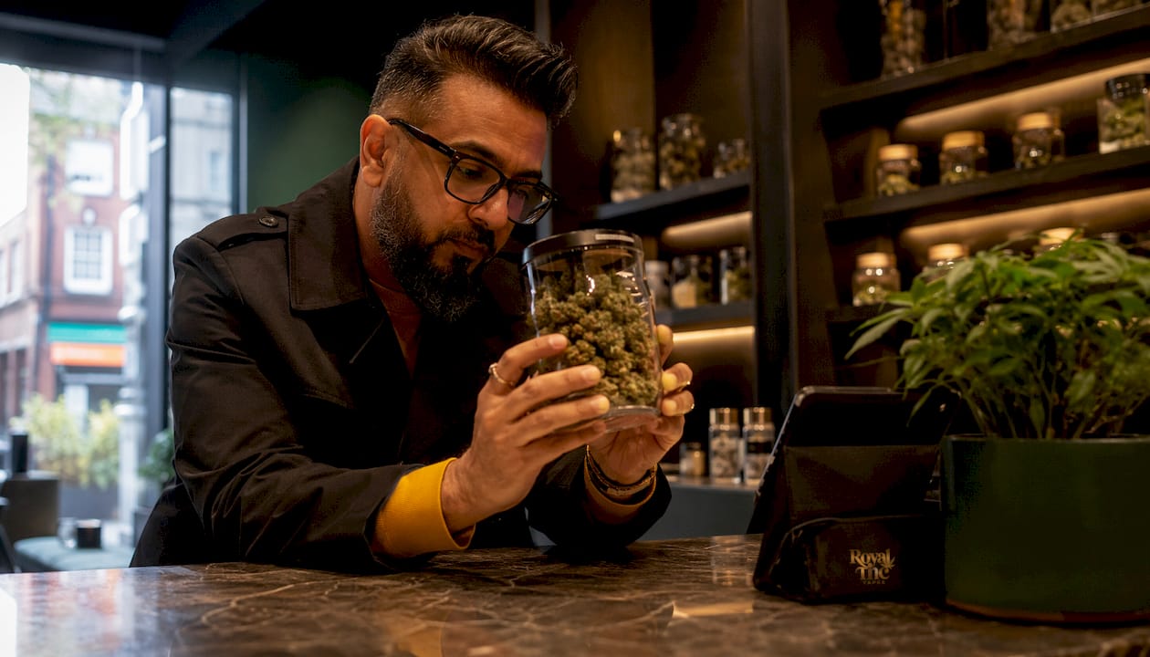 Man inspecting indica gummies in dispensary