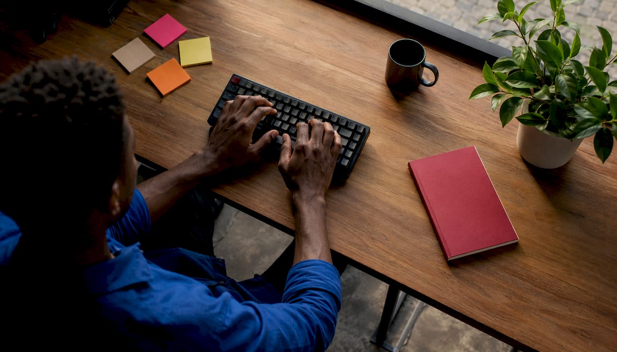 Developer coding at desk close-up