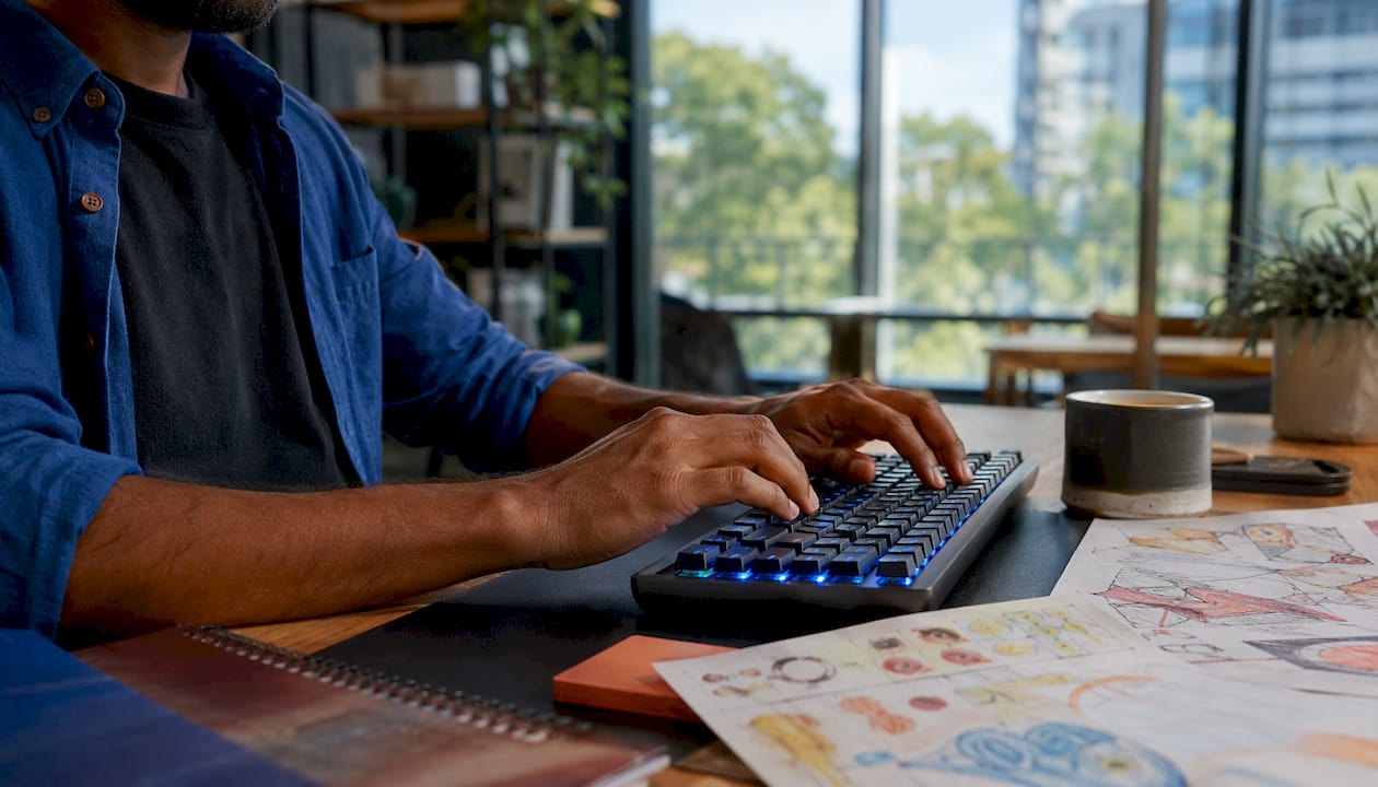 Hands typing on keyboard at web design project