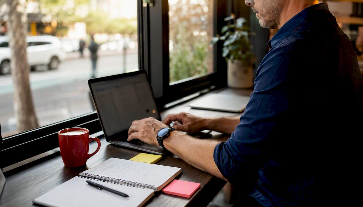 Hands typing on keyboard in developer workspace