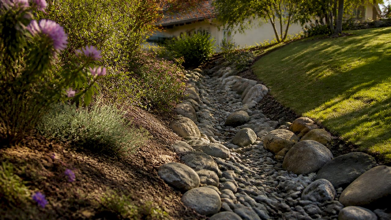 Dry creek bed curving with river rocks