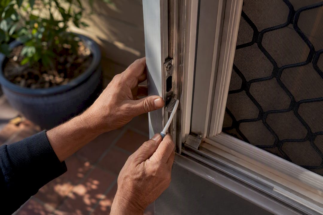 Hand cleaning security screen frame and lock with toothbrush
