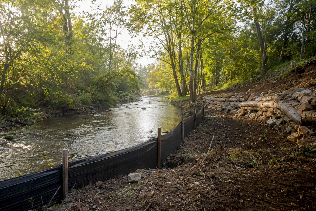 Silt fencing controlling sediment runoff near creek