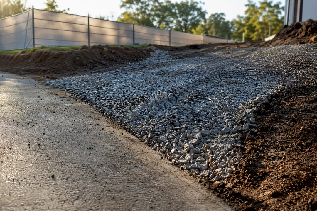Coarse aggregate construction entrance beside road