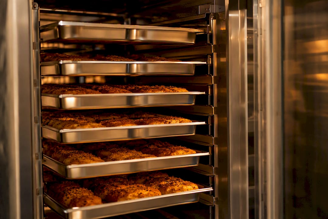 Gastronorm pans loaded on oven racks