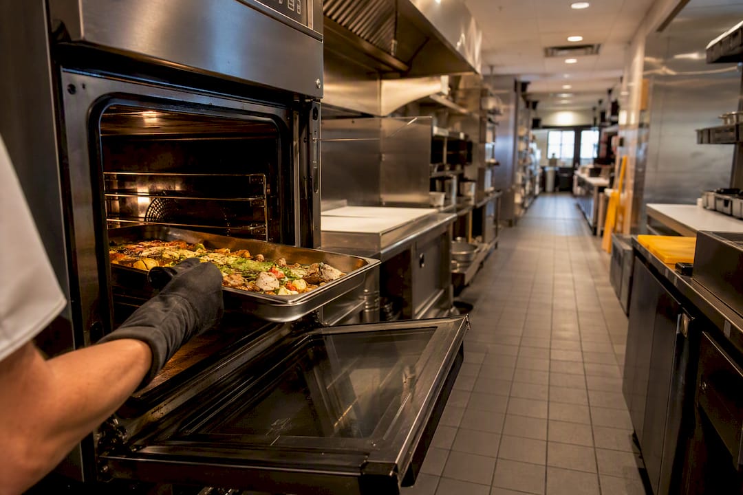 Corridor space with open oven door and loaded pan