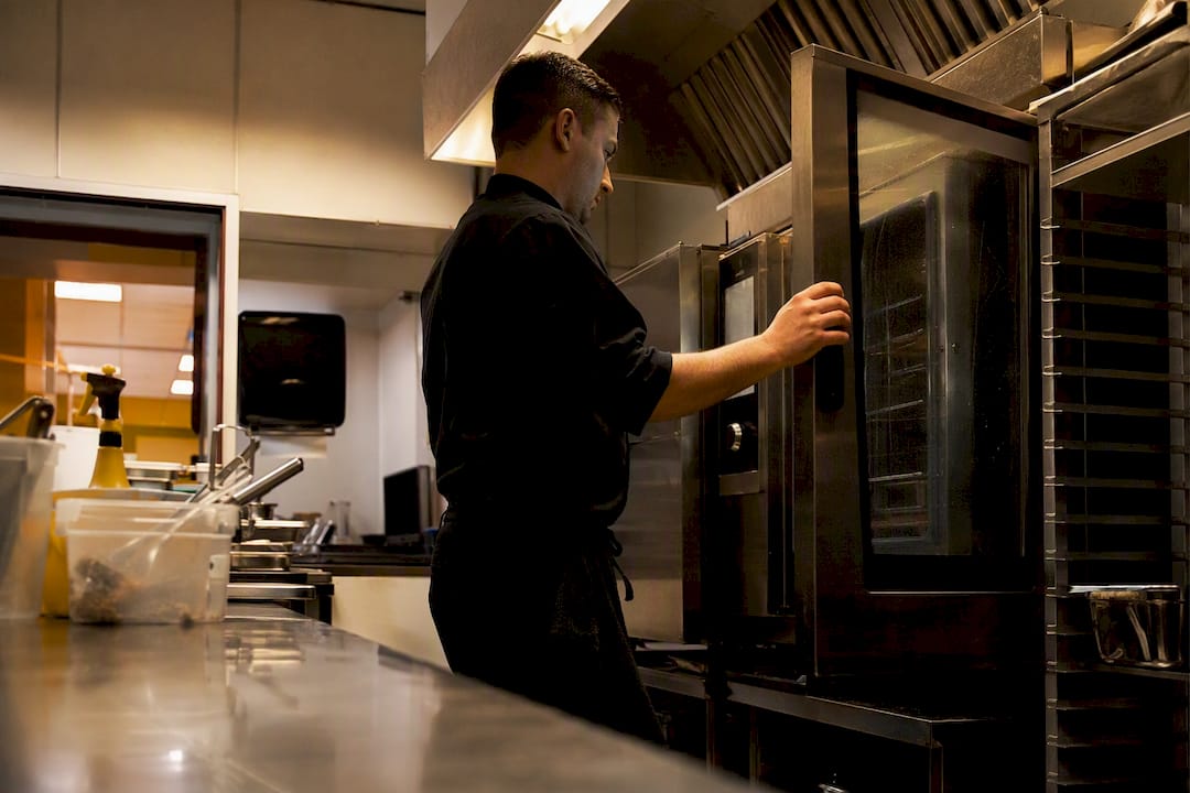 Chef closing combi oven door for nightly clean
