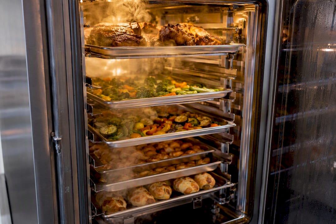 Steam-filled commercial oven with multi-level food racks