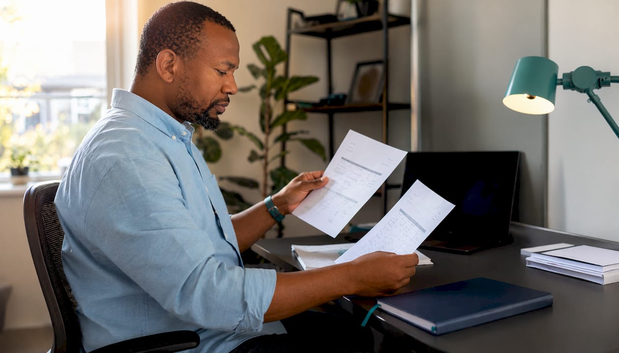 Hands checking invoice and contract documents