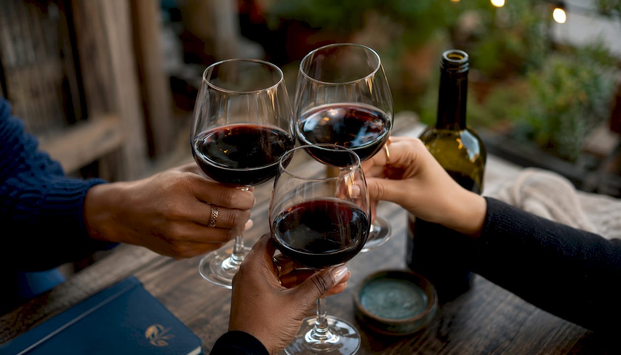 Hands holding white wine glass close-up