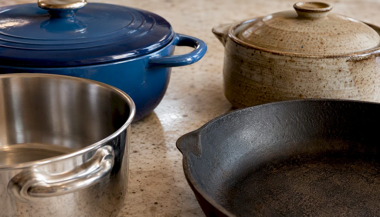 Close-up of pots made of copper, stainless, carbon steel, nonstick