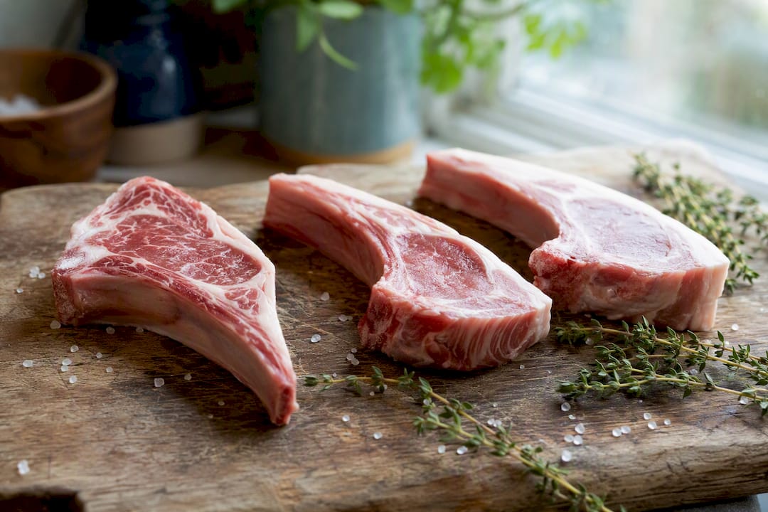 Raw lamb chops showing USDA grades