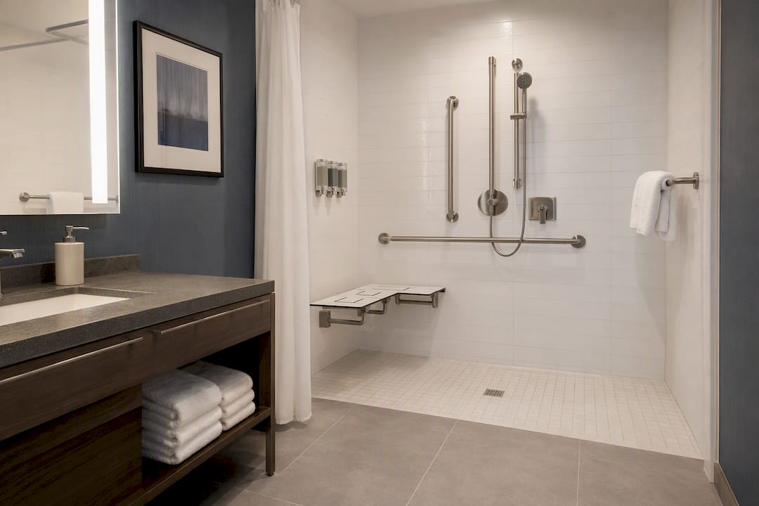 Accessible hotel bathroom with roll-in shower