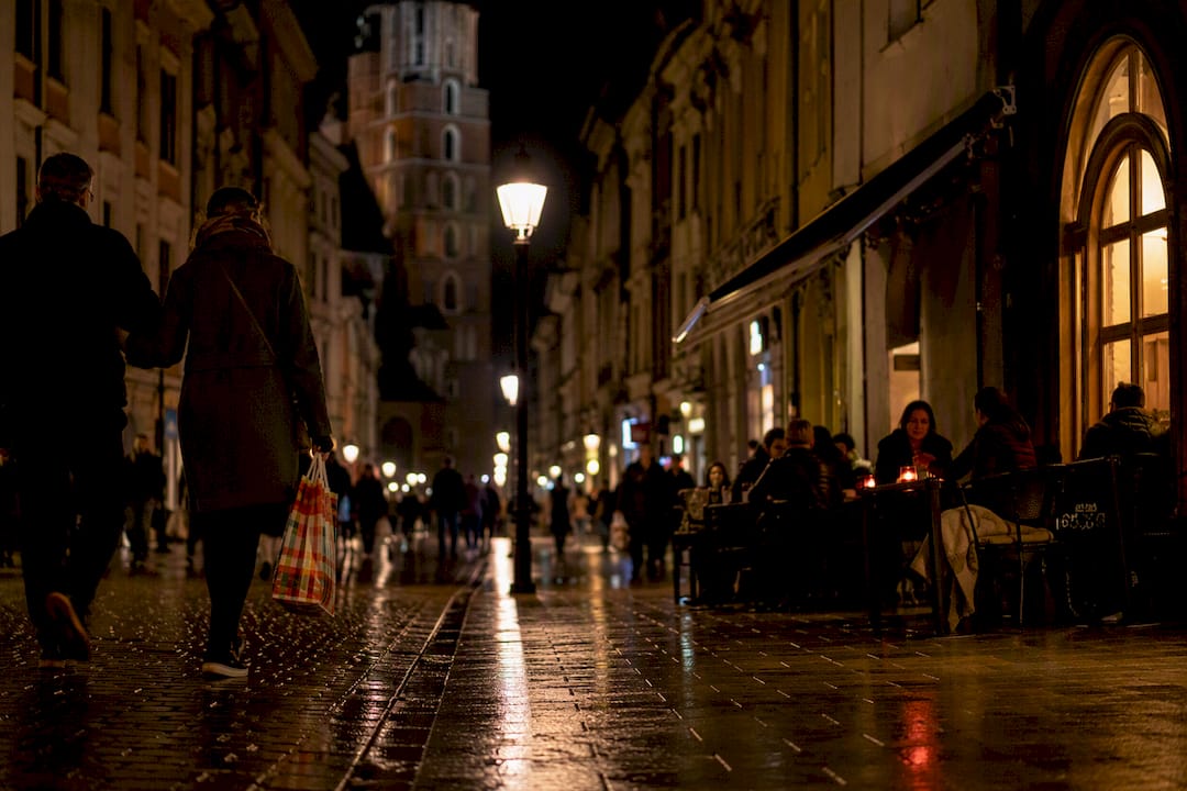Well-lit Old Town street with pedestrians at night