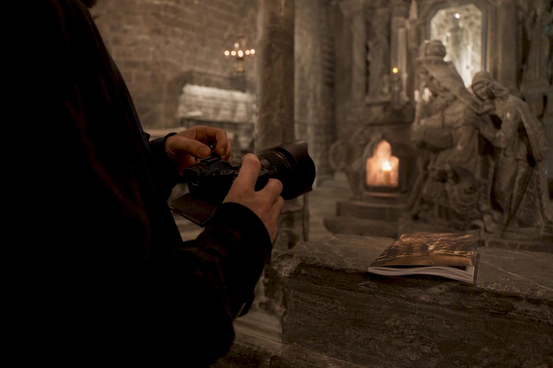 Visitor adjusting camera without flash in chapel