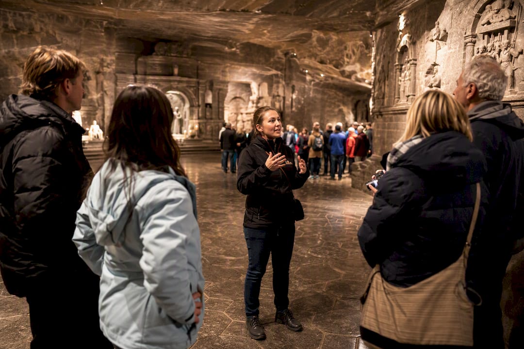 Private tour guide with small group inside the mining chamber