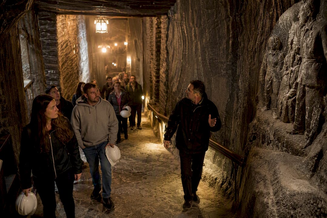 Tour group walking inside Wieliczka Salt Mine corridor