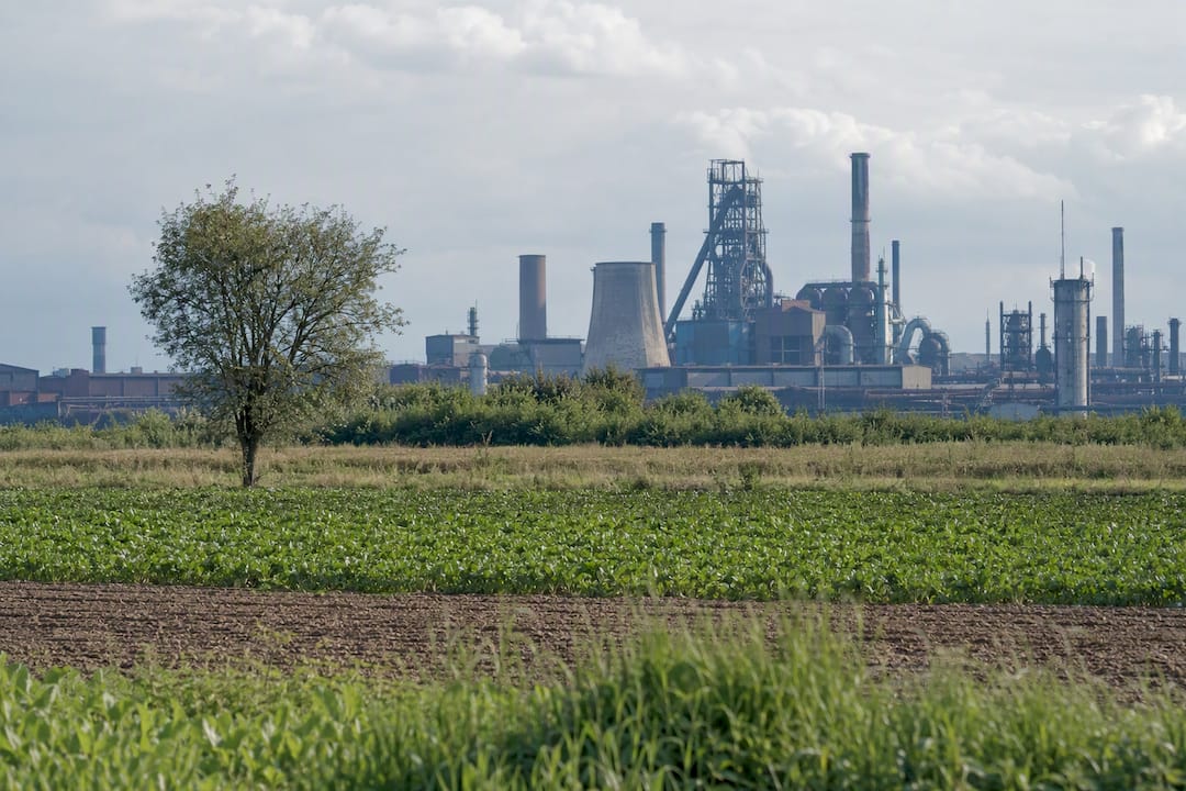 Farmland beside Nowa Huta industrial skyline