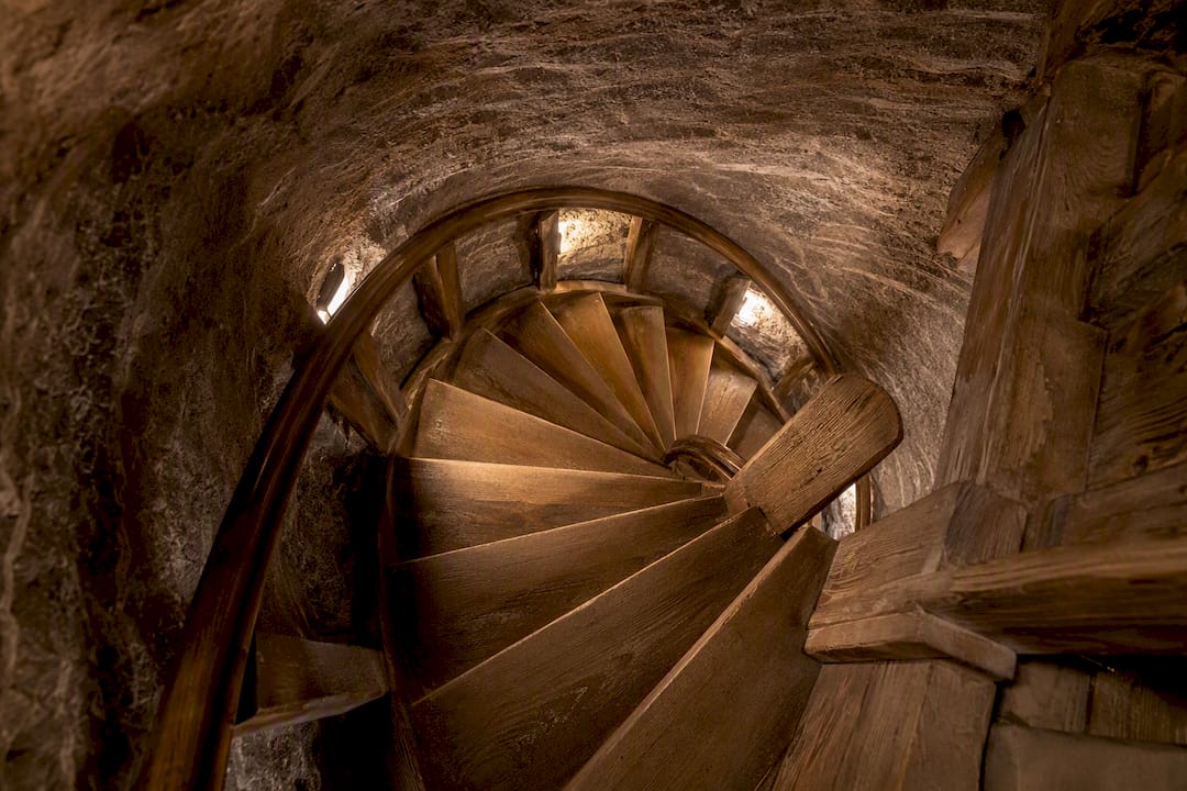 Narrow spiral staircase in salt mine