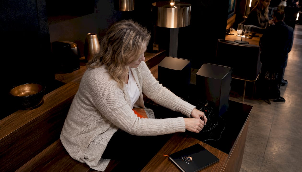 Woman setting up Bluesound speakers at home
