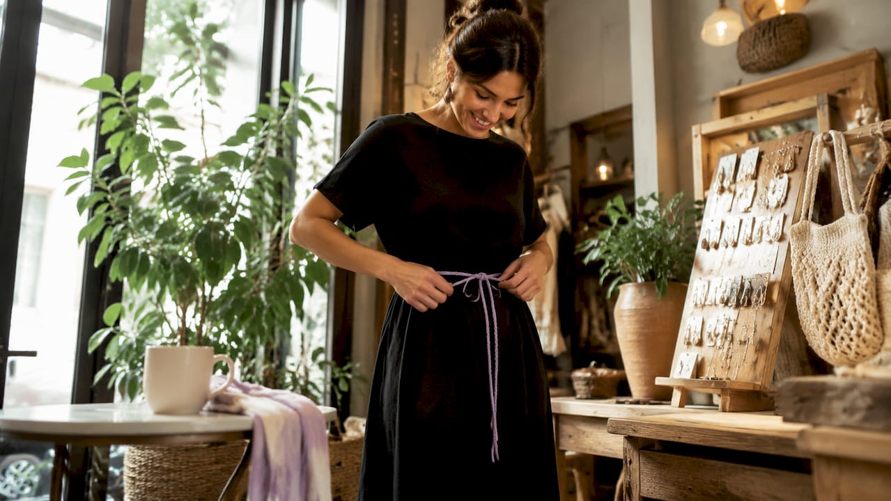 Woman wearing black dress with leather belt