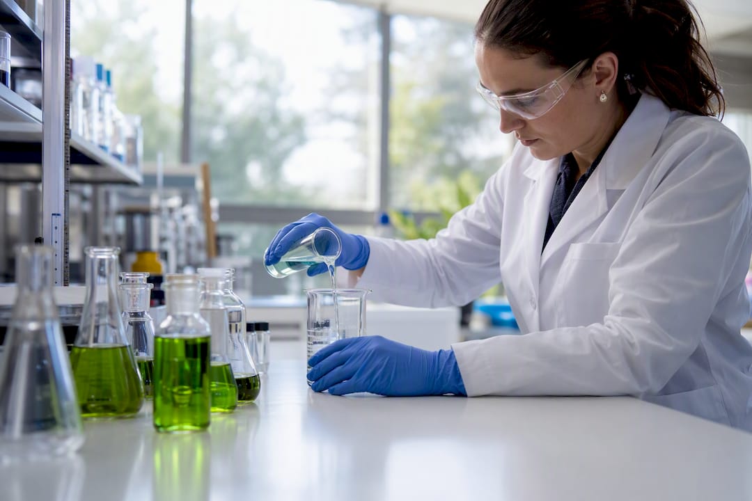 Hands handling green chemistry solvent in lab