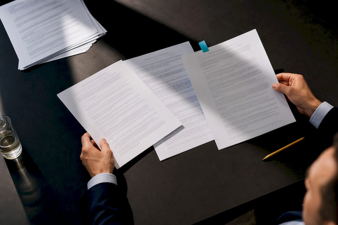 Hands drafting chemical supply contract clauses
